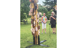 Artist Michèle AimPée Parent standing next to her work Sounds of Fossilized Mouths with Denis Marceau, President of the Centre d’art contemporain de l’Outaouais (CACO), who is presenting it to visitors. Photo: Antoine Bourdages